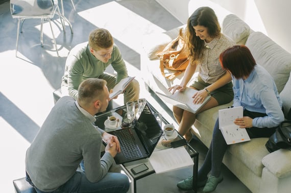 professionals having a discussion around coffee table